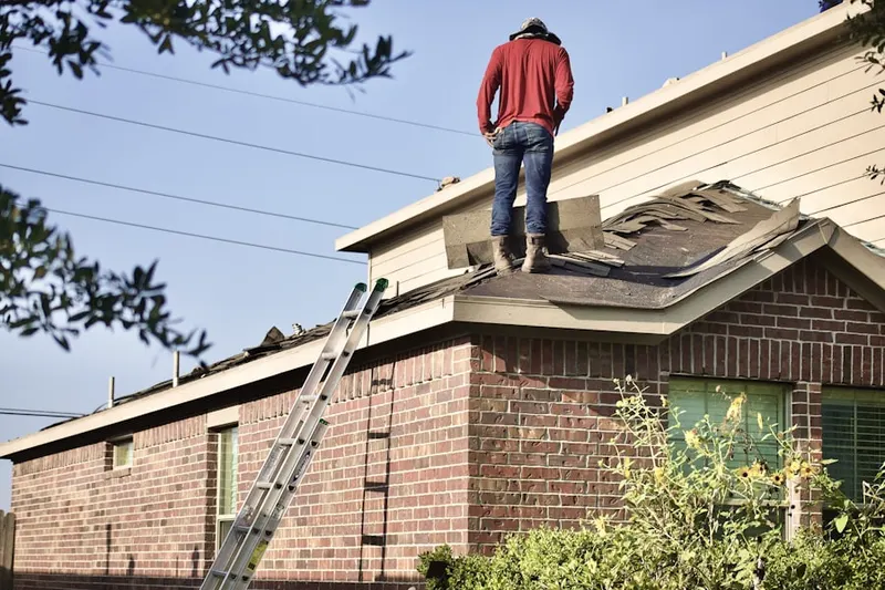 Professional roofer working on a residential roof in Pavia